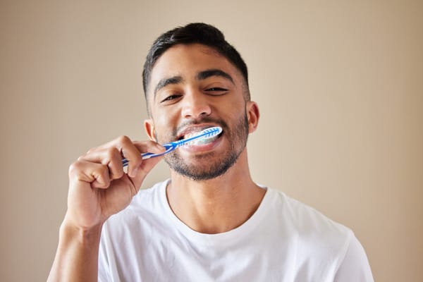 Man cleaning his teeth with toothbrush